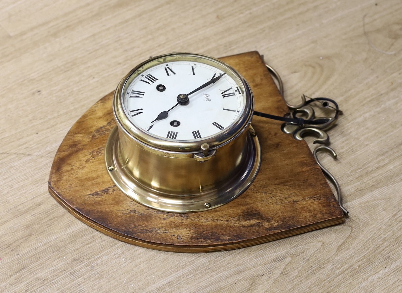 A Schatz brass bulkhead timepiece, mounted